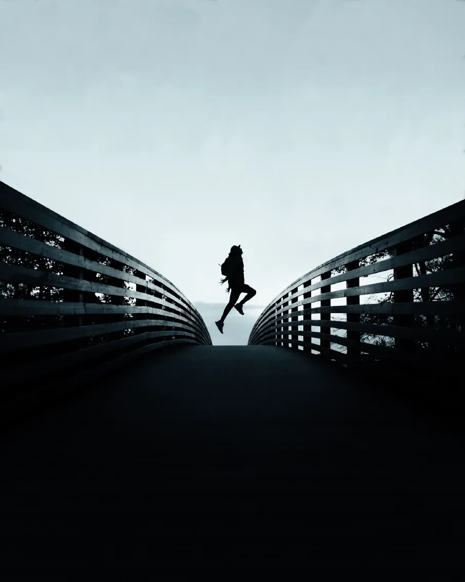 person jumping over the bridge